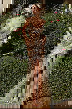 Front view of beaded spaghetti strap gown with front slit