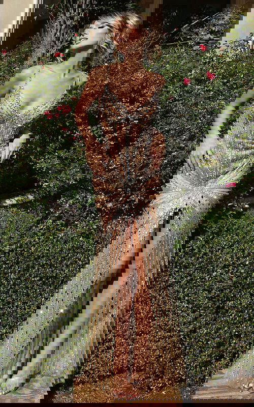 Front view of beaded spaghetti strap gown with front slit