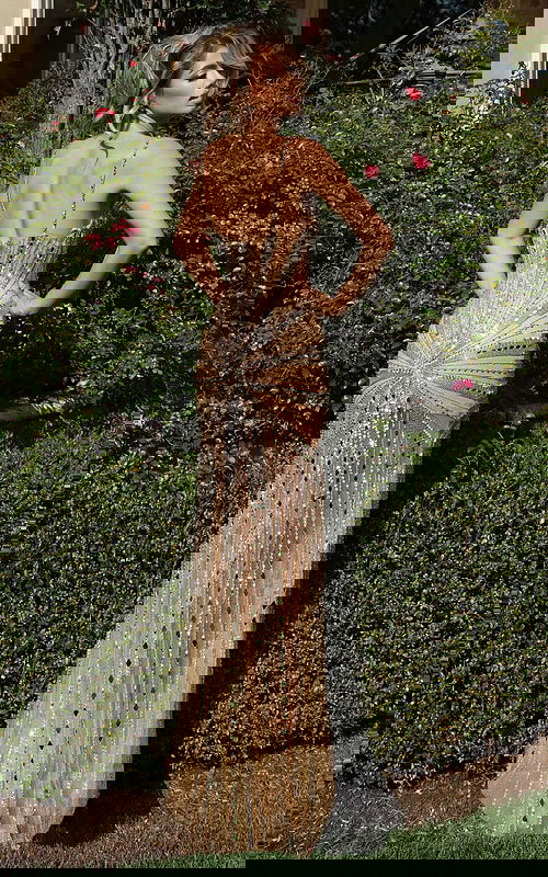 Back view of fitted sequin gown with open back and shimmering design