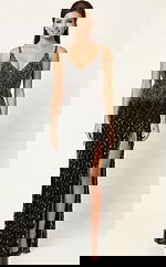 Front view of a fitted gown with a deep V neckline, geometric beadwork, and a thigh high slit