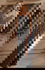 Fitted beaded gown with a sweetheart neckline, intricate patterning, and a thigh high slit creating a sleek, elegant look