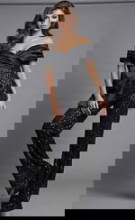 Front view of beaded wide leg jumpsuit with off shoulder draped neckline, fitted waist, and flowing pant