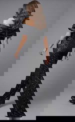 Back view of beaded wide leg jumpsuit with off shoulder draped neckline, fitted waist, and flowing pants