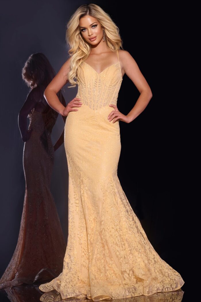 Model wearing Jovani 44142 beige mermaid gown front view with hands on hips