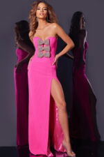 Model wearing Jovani 44155 pink gown with bow details and high slit, close-up front view.