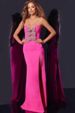 Model wearing Jovani 44155 pink gown with bow details and high slit, front view.