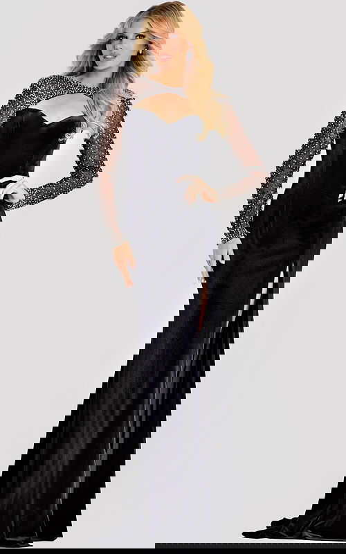 Black velvet evening gown featuring sheer long sleeves embellished with crystals, a sweetheart neckline with a front cutout, and a high slit for a sophisticated finish.