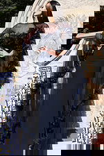 Elegant long navy gown featuring 3D floral trim on cape