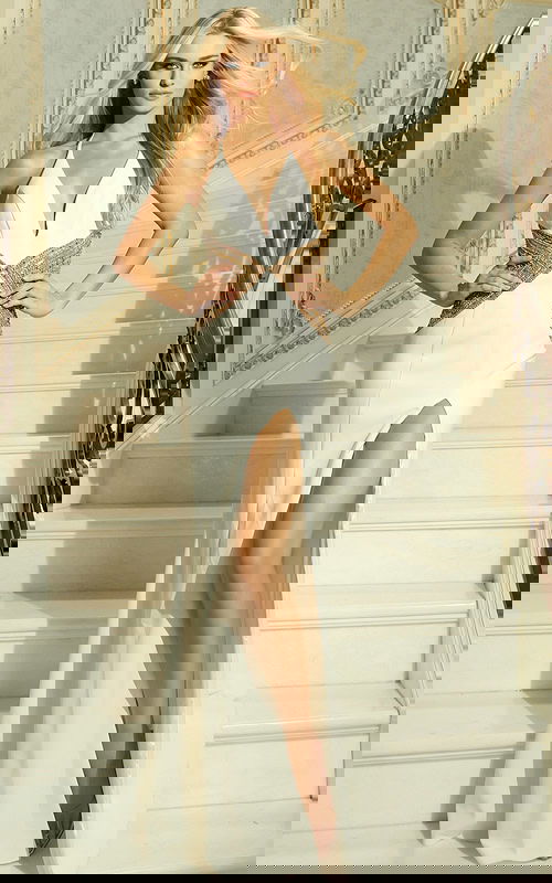 Model wearing halter gown with plunging neckline and beaded waist