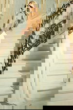 Back view of halter evening gown with open back and flowing train