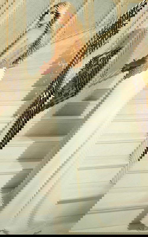 Back view of halter evening gown with open back and flowing train