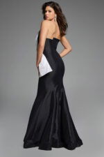 Back view of strapless black mermaid gown featuring a dramatic white bow accent.