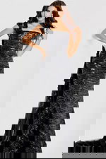 One-shoulder fitted gown adorned with black sequins, featuring floral appliqué accents and a sheer tulle train.