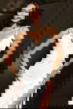 Sophisticated white formal dress with shimmering accessories and slit