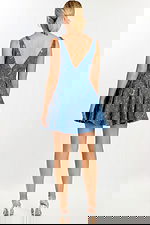 Back view of sleeveless mini dress with low V-cut and floral embellishments