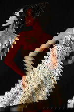 Back view of ivory sequin tweed dress with feather details on straps