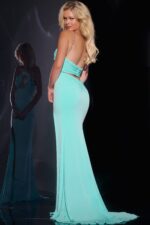 model wearing Jovani 44496 with mint A-line halter dress back view