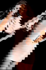 Elegant open back dress featuring bow tie detail and voluminous sleeves