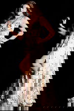 Romantic open-back evening dress with layered floral tulle and shimmer finish.