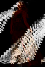 Elegant sleeveless dress featuring sheer bodice and soft floral applique details