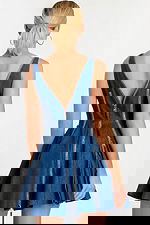 Back view showing V-cut back and central zipper detail on flared denim dress