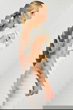 Side-back angle highlighting floral texture and fitted silhouette of the off-white ensemble