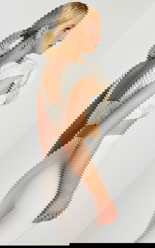 Side-back angle highlighting floral texture and fitted silhouette of the off-white ensemble