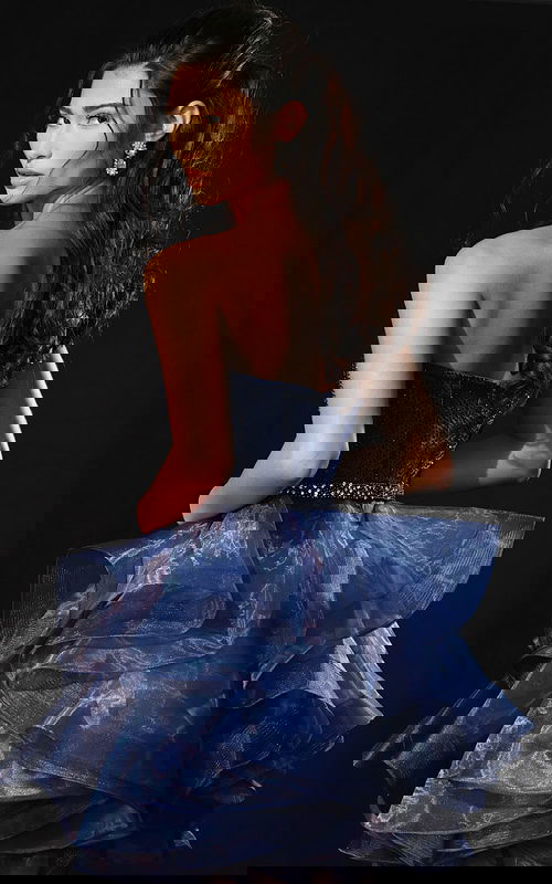 Back view of strapless organza dress with ruffled skirt and fitted bodice