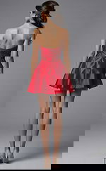 Back view of strapless short formal dress with fitted beaded bodice and flared skirt