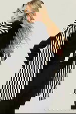 Fashion-forward black blazer and pants with dramatic bow shoulders