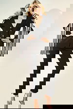 Black fitted suit with striped oversized bow detail