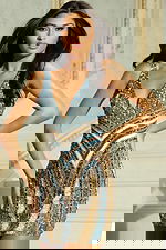 Model wearing multicolor beaded mini dress with deep V neckline