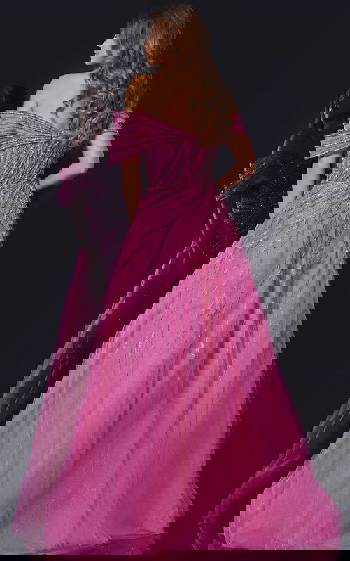 Model wearing Jovani 45067 fuchsia gown, back view showing elegant flow and off-the-shoulder design.