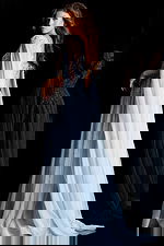 Light blue beaded gown with flowing sheer cape and deep V neckline