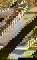 Back view of fitted gown with sheer beaded long sleeves, smooth skirt, and elegant floor length silhouette