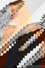 Close-up of crystal beaded halter neckline with double teardrop cutout on black gown