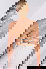 Back view of lace-up strappy halter crop top with open back