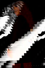 Elegant white fitted dress featuring multicolor gem embellishments on collar and cuffs