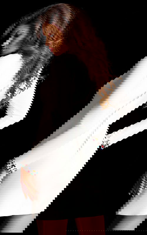 Elegant white fitted dress featuring multicolor gem embellishments on collar and cuffs