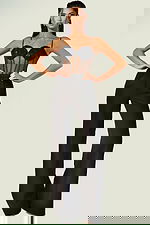 Black fitted jumpsuit featuring sheer bodice and spaghetti straps