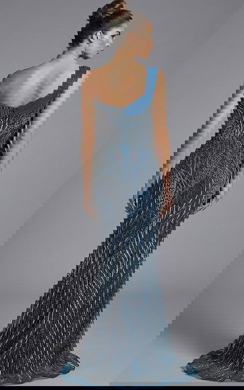 Back view of one shoulder fully beaded gown with fitted silhouette and train