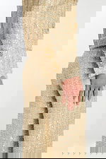 Close-up of sleeve cuff detailing with pearl and bead buttons