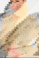 Detailed view of sequin tweed texture and floral pearl buttons