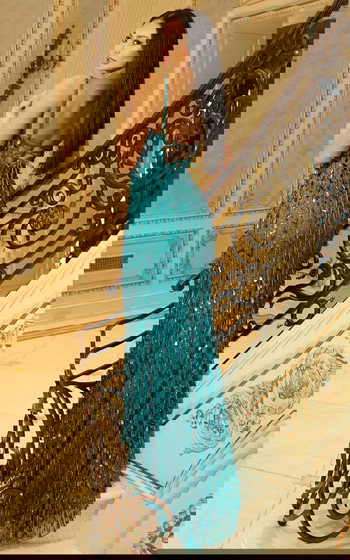 Fitted evening gown with sequin embellishments and lace-up back