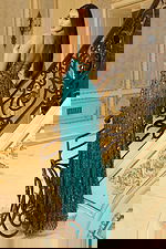 Fitted evening gown with sequin embellishments and lace-up back