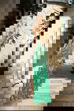 Green beaded prom dress with spaghetti straps and thigh-high slit