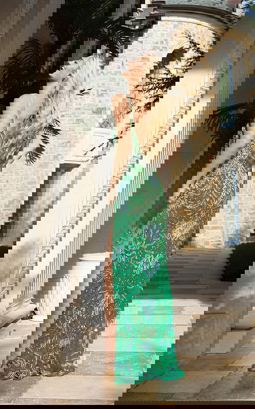 Green beaded prom dress with spaghetti straps and thigh-high slit