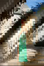 Sparkling green dress with side slit and intricate bead details