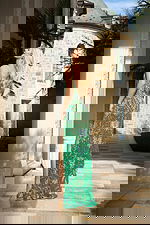 Backless green beaded dress with long silhouette and flowing hem