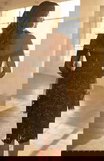 Back view of strapless lace dress with sheer overlay and center slit